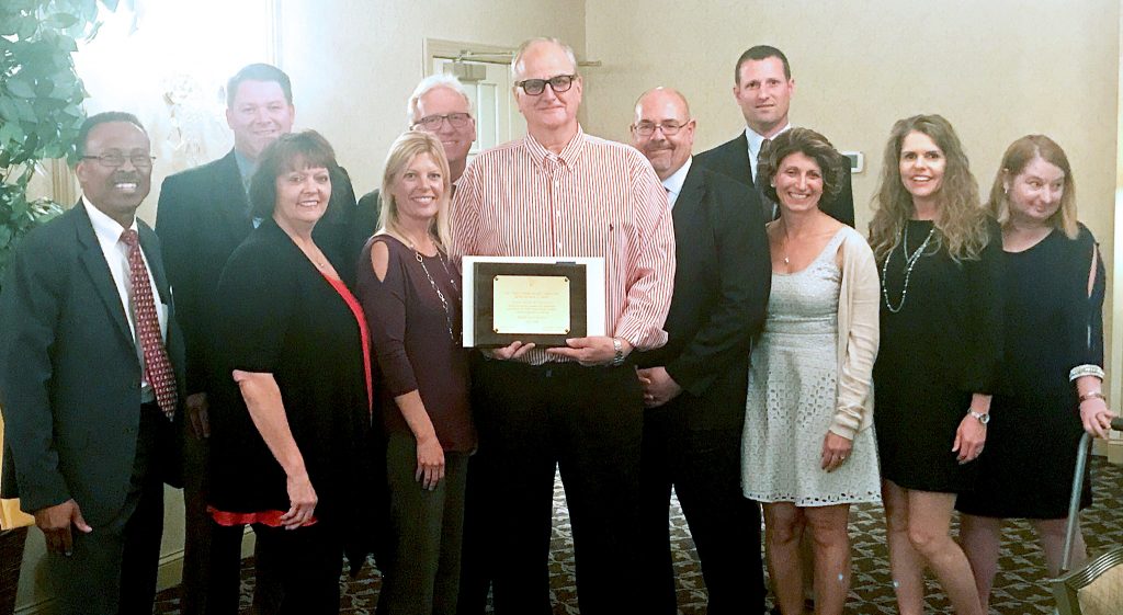 The Delran School Board received recognition for Board Certification from the NJSBA Board Member Academy, at the Burlington County School Boards Association’s final meeting of the year. Pictured is the full Delran board, with (President Glen Kitley holding the plaque.) NJSBA field services representative Jesse Adams is at far left.