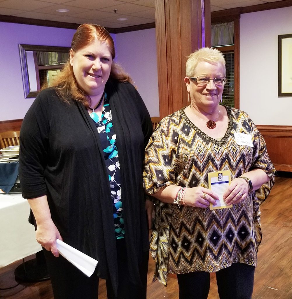 Jackie Bermudez (left) president of the Ocean County School Boards Association, congratulates Joan Speroni, of the Point Pleasant Borough School Board, for her 15 years of service. 