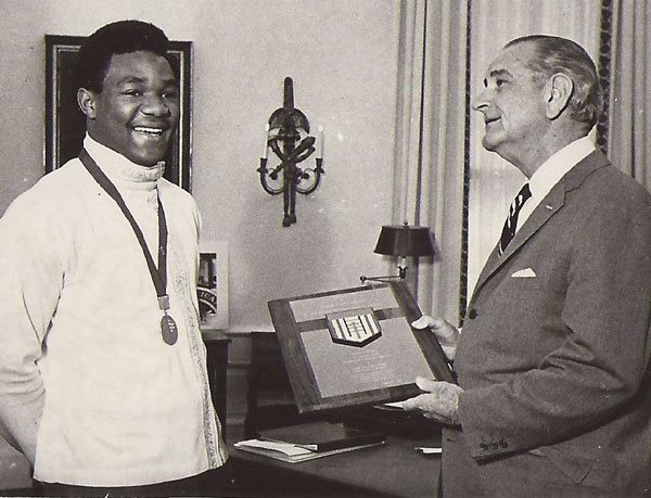 In 1968, President Lyndon Johnson recognized the success of boxer George Foreman, who acknowledged how he got his head start in life from the Job Corps program. (Photos provided by Pete Calvo.) 