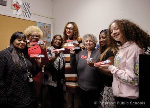 Eileen F. Shafer, superintendent of Paterson Public Schools, third from right, and other district, school and city officials and a student show their appreciation of Colgate-Palmolive’s donation of dental care products to the Confidence Closets.
