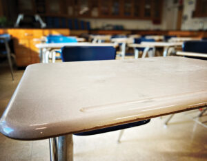 photo of a desk in an empty classroom