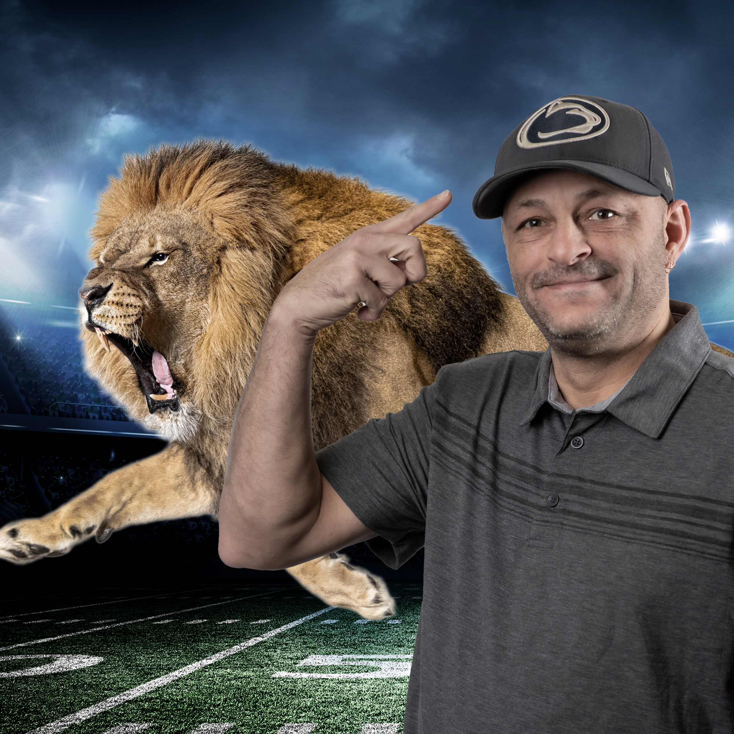 Brian pointing at his UPenn Lions hat in front of a lion on a football stadium.
