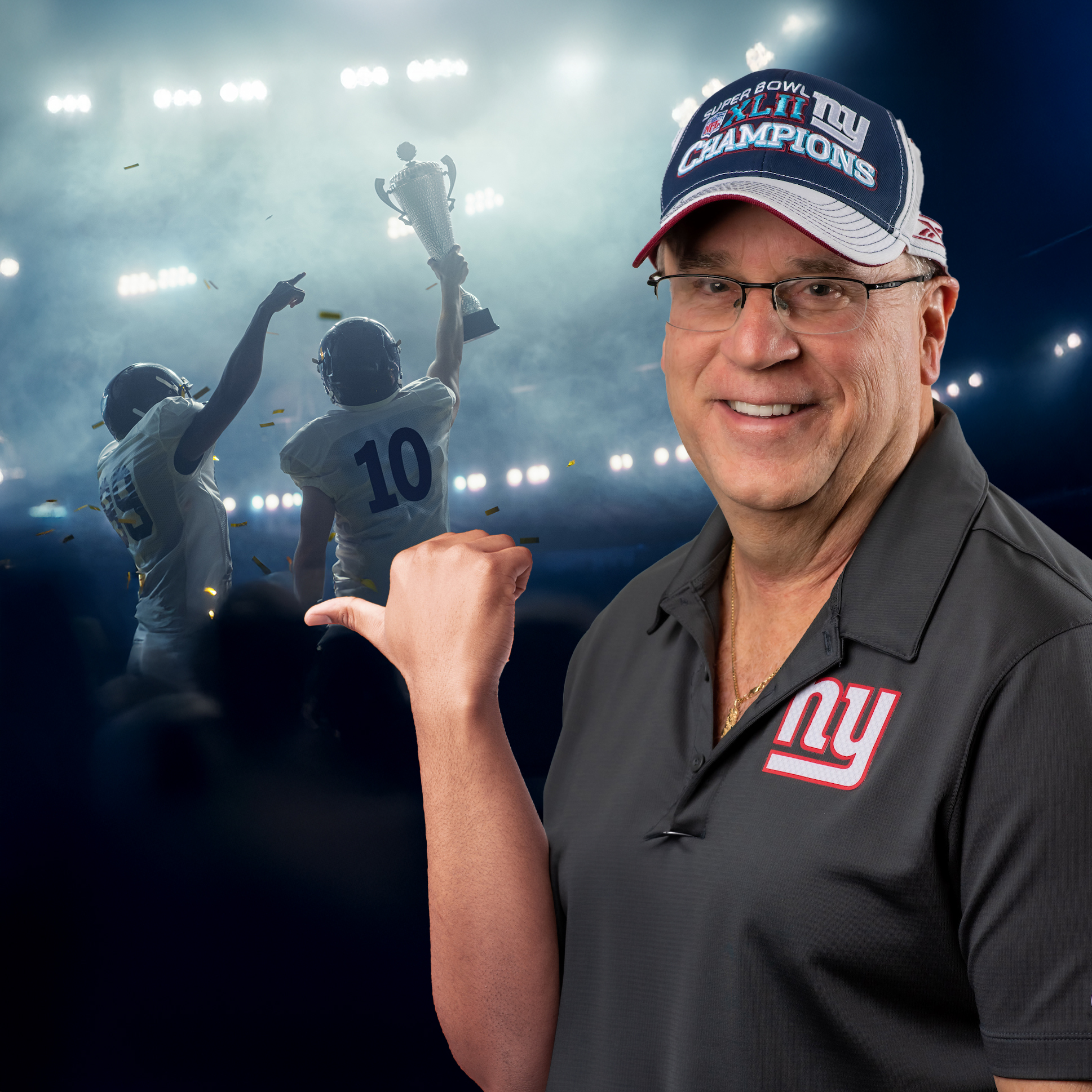 Michael Melando in NY Giants shirt, pointing his thumb to football champions behind him.