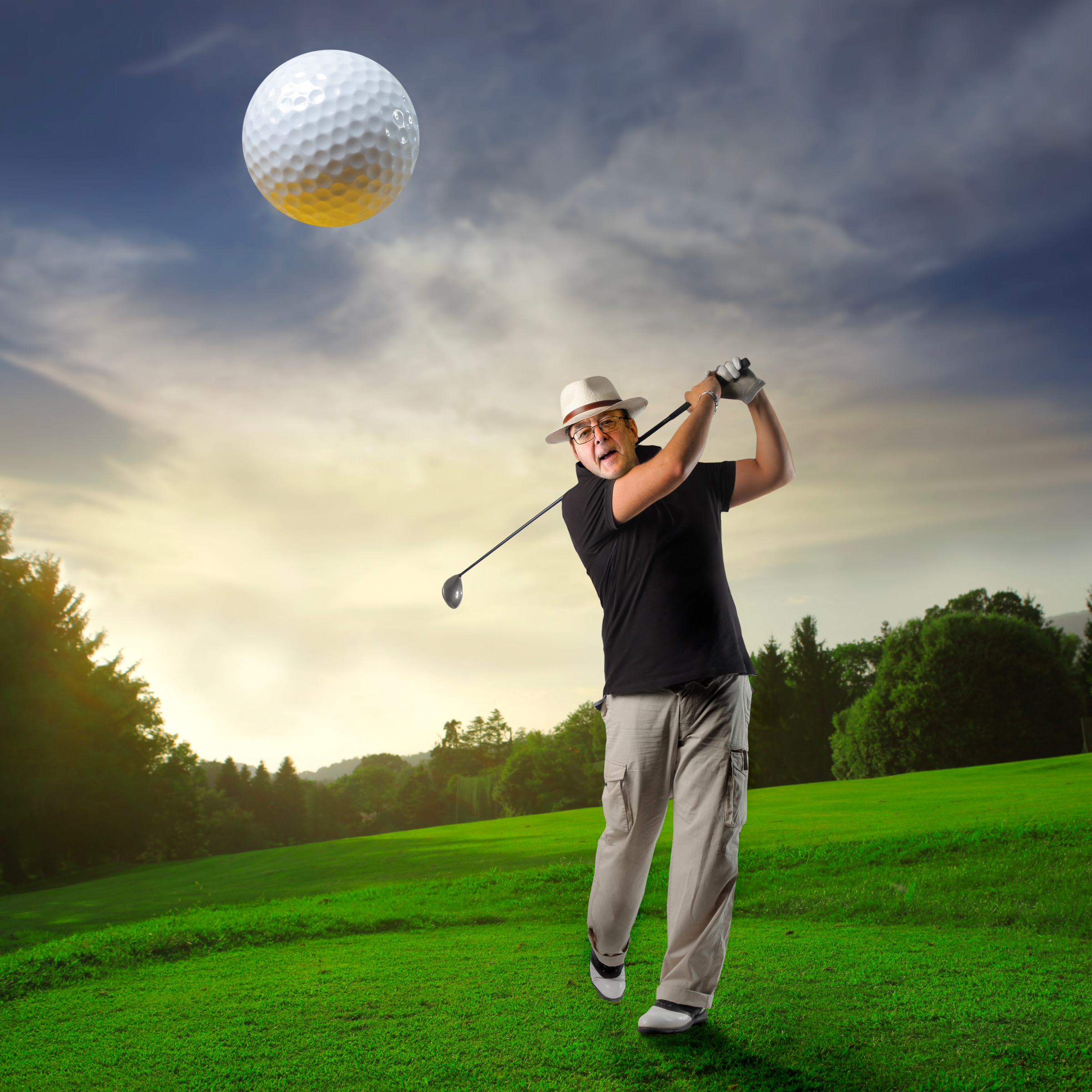 Charles hitting a golfball.