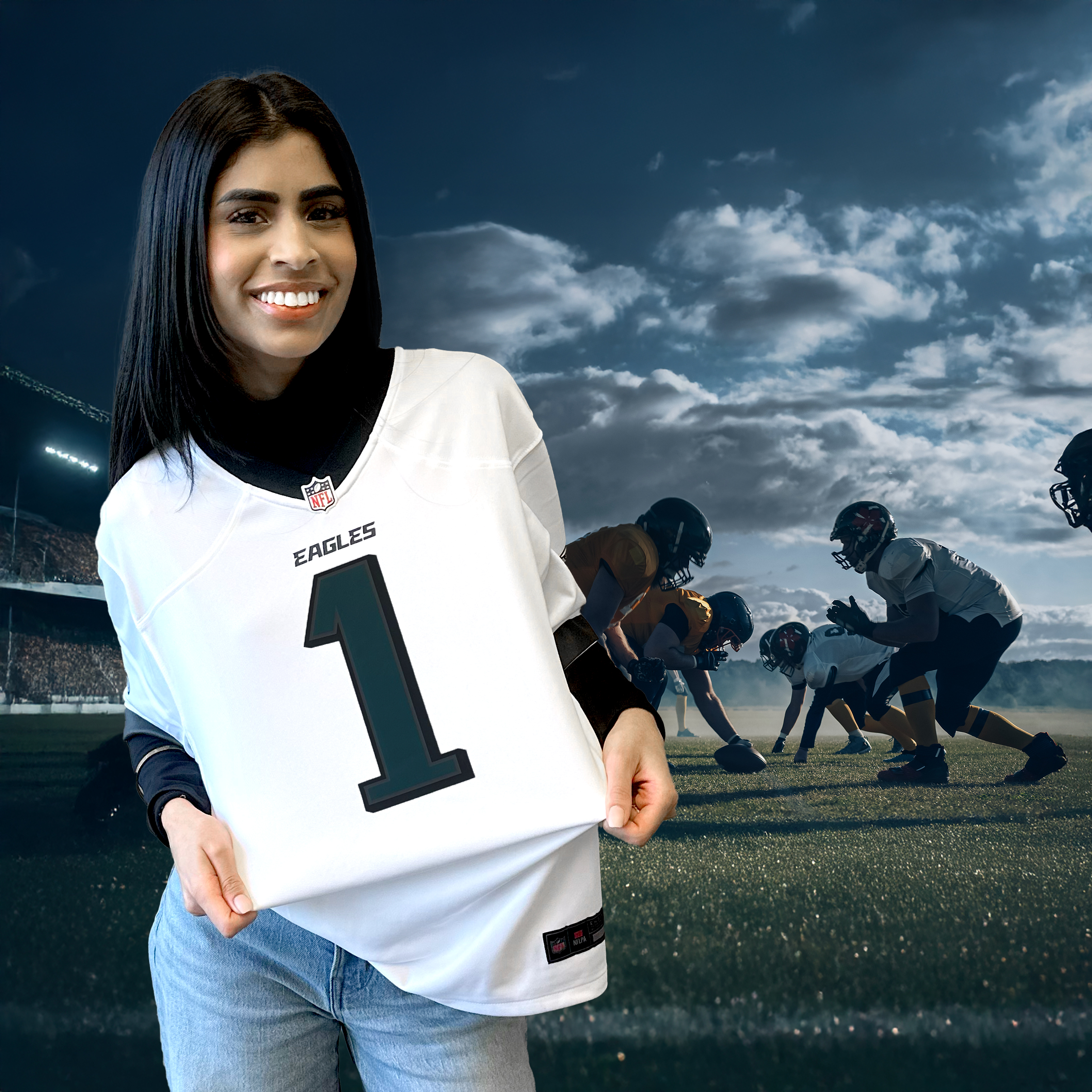 Soumya posing with her sports jersey in front of a football field.