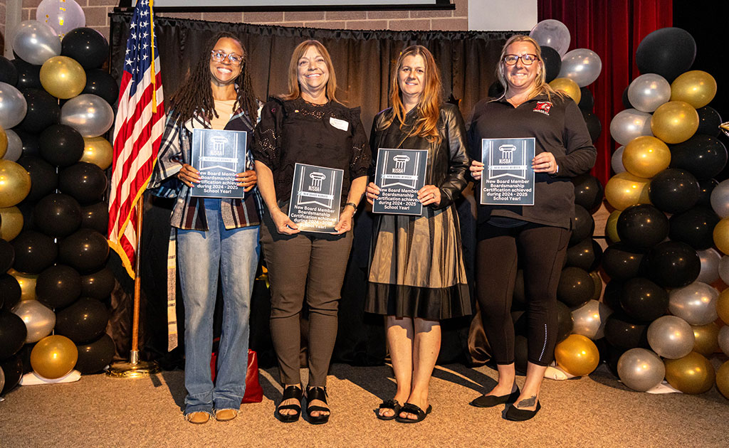 group of people posing with awards