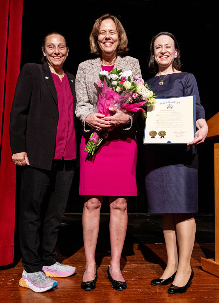 group of people posing with an award