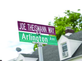 close-up of street signs that say "Joe Theismann Way" and "Arlington Ave"