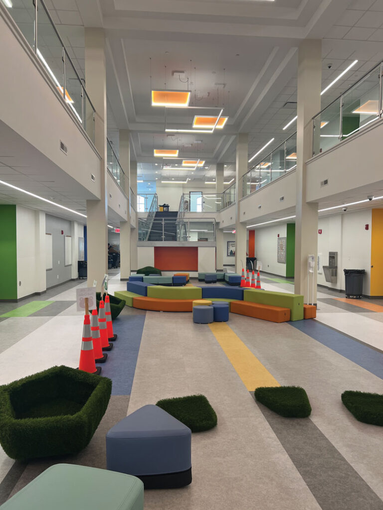Two-story atrium featuring colorful movable soft seating 