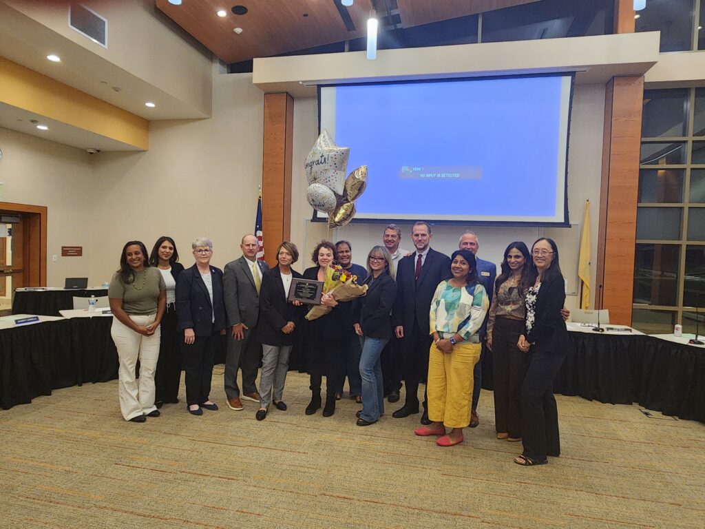 2025-2026 Board Member of the Year Dana Krug, posing in picture with NJSBA staff, board members, and family.