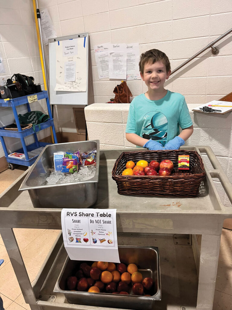 A student from Round Valley Elementary School at  a sustainable food  share table.