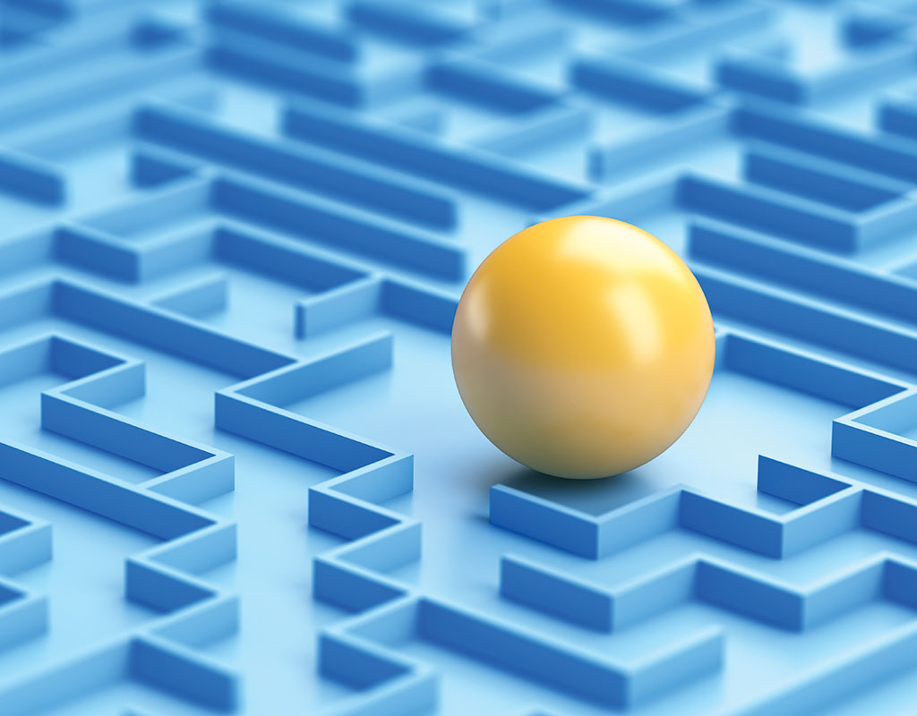 closeup of a yellow ball in a blue maze