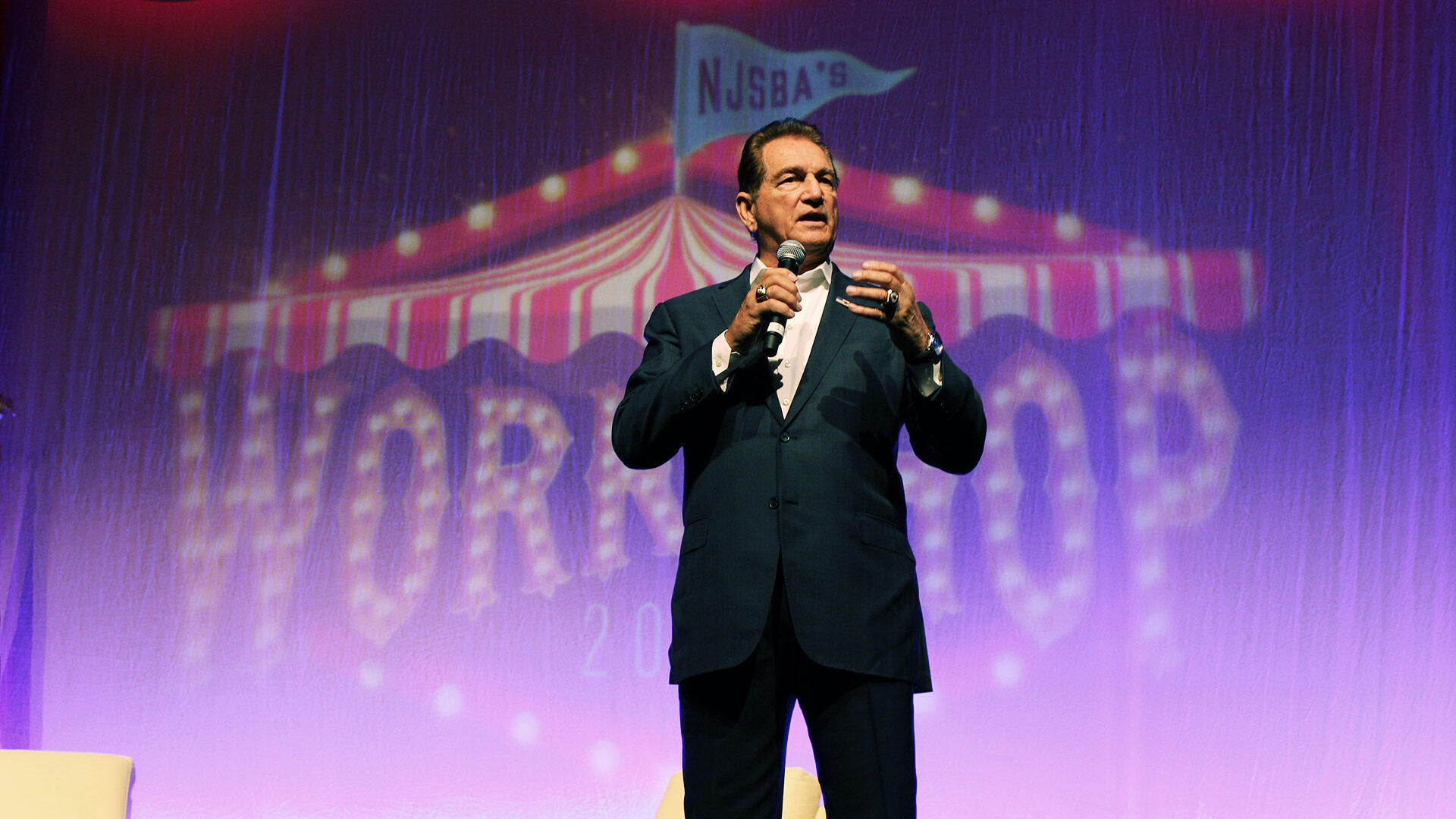 closeup of Joe Theismann giving a keynote address at workshop 2025
