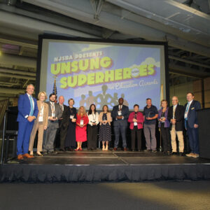group of people on a stage receiving awards