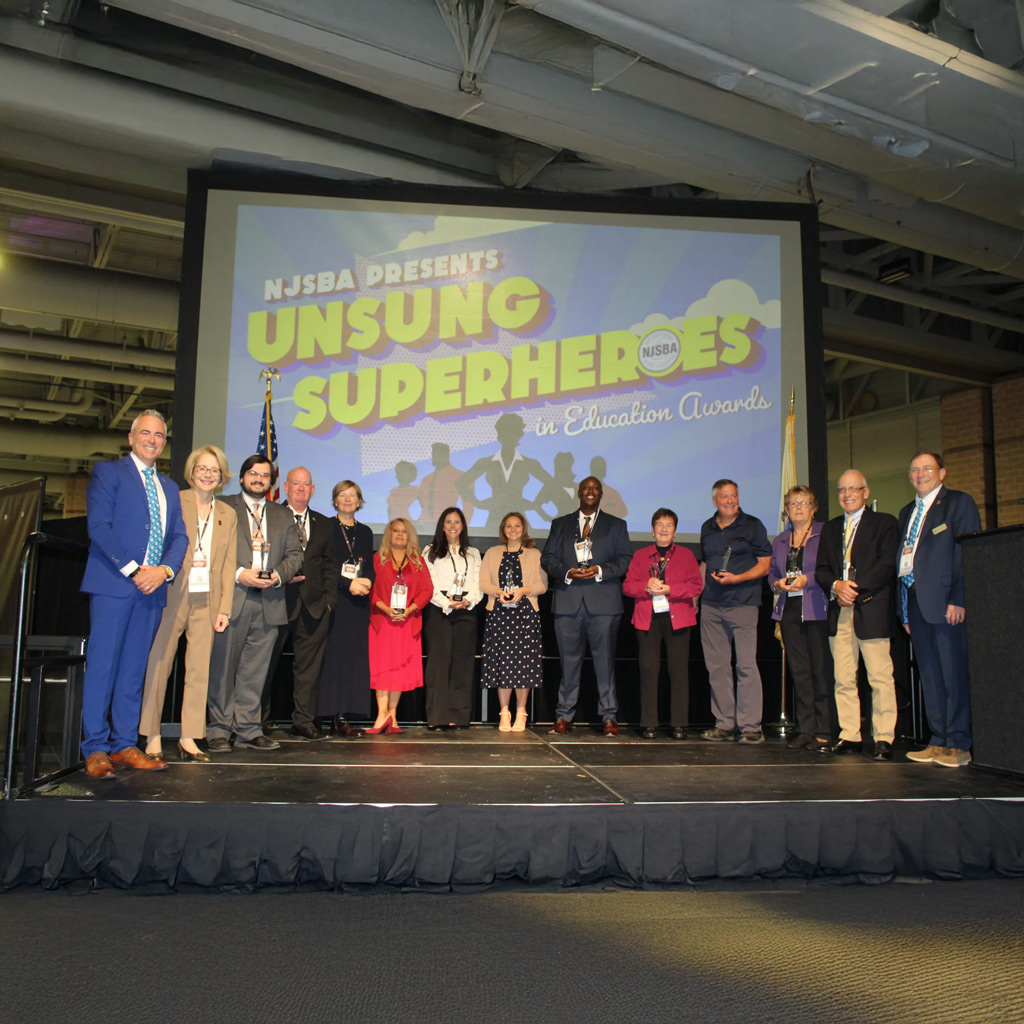 group of people on a stage receiving awards