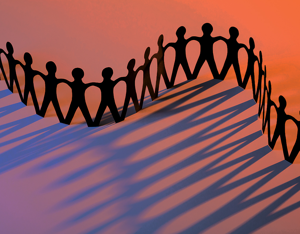 paper cutout silhouettes holding hands in a wavy line with a pink to purple gradient background