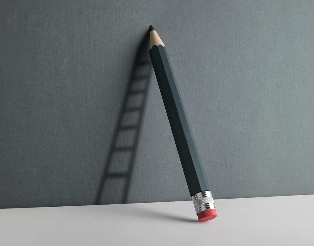 A lifesize gray pencil leans against a lighter gray wall casting a shadow of a ladder.