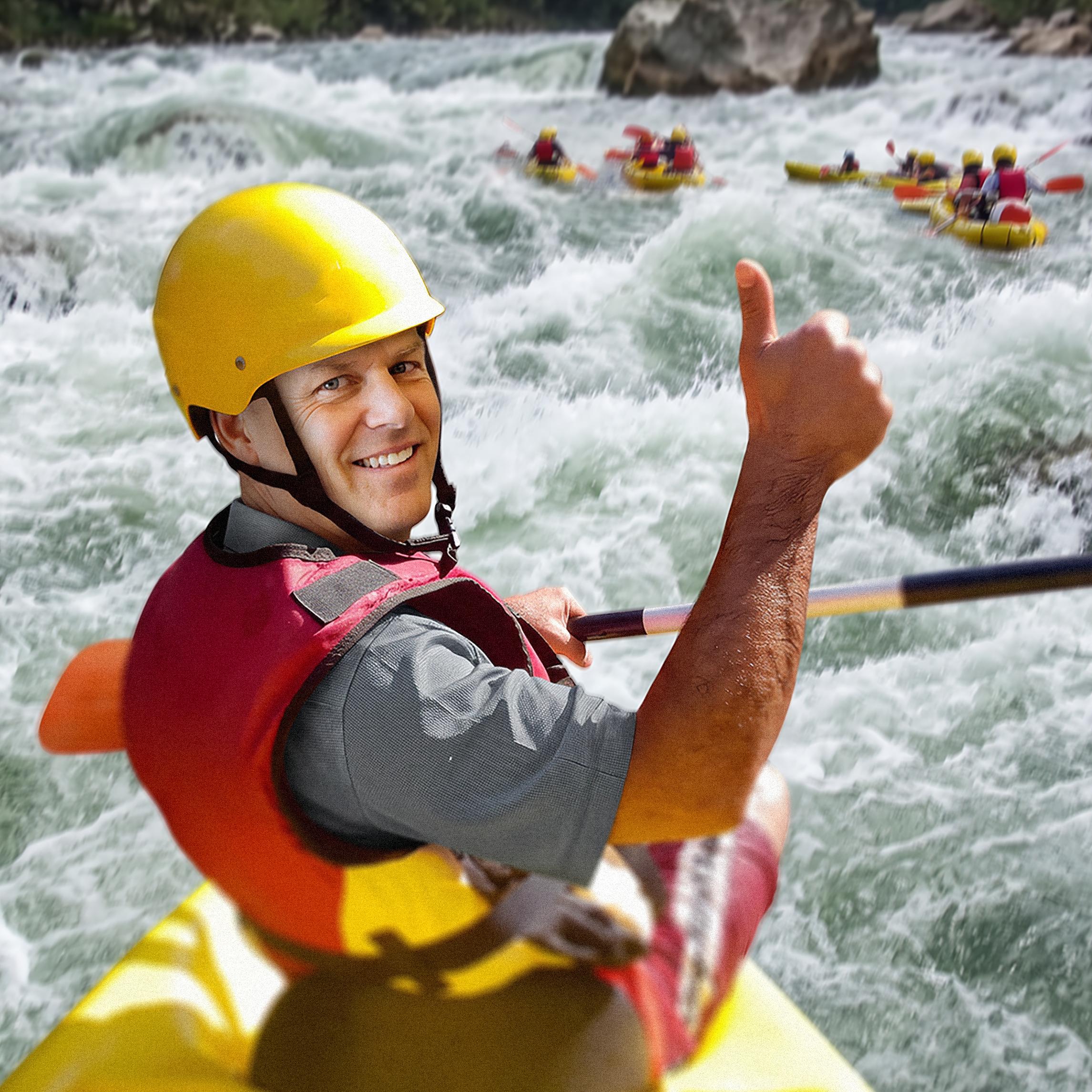 Todd on a kayak in turbulent water giving a tumbs up.
