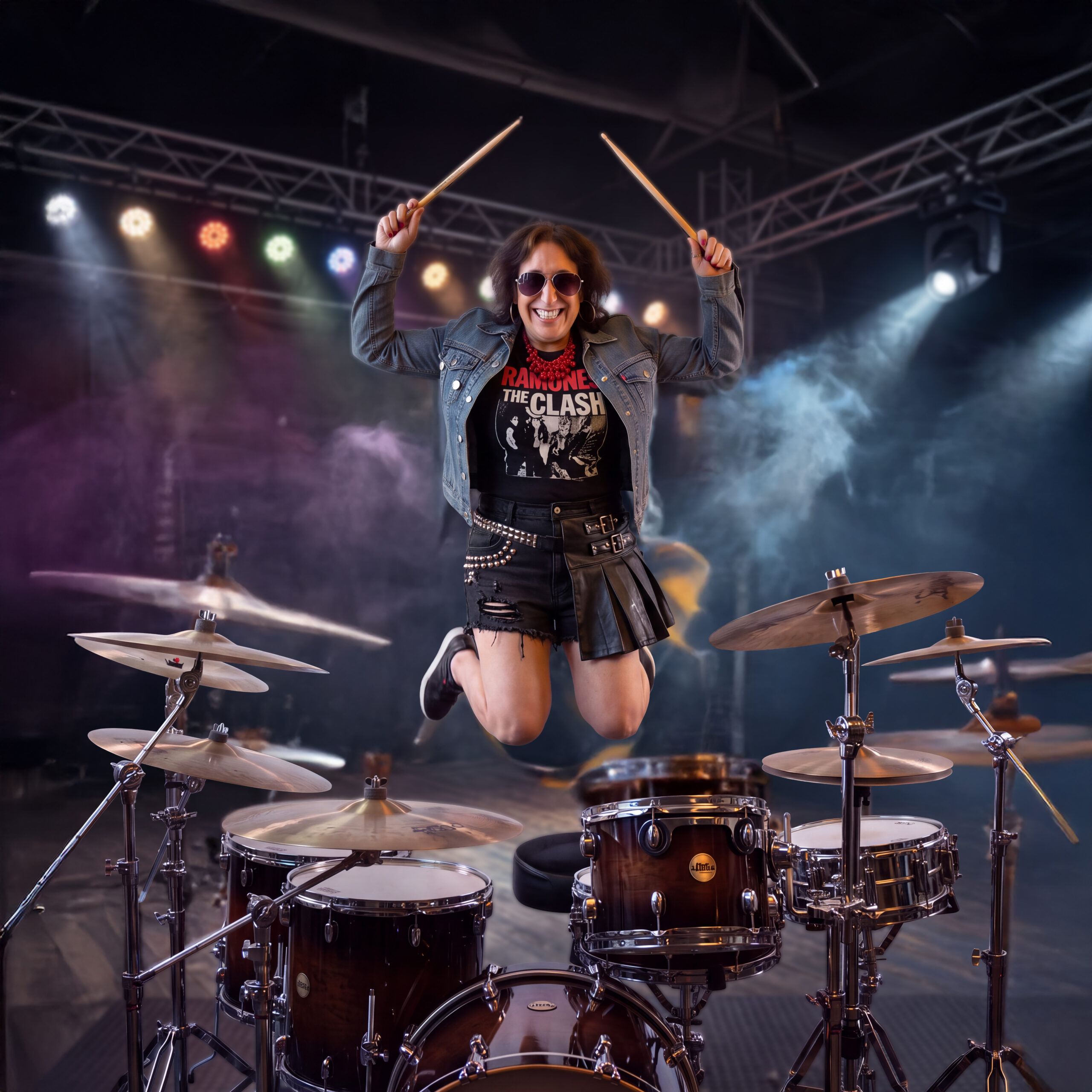Dawn jumping in the air with her drumsticks on stage.