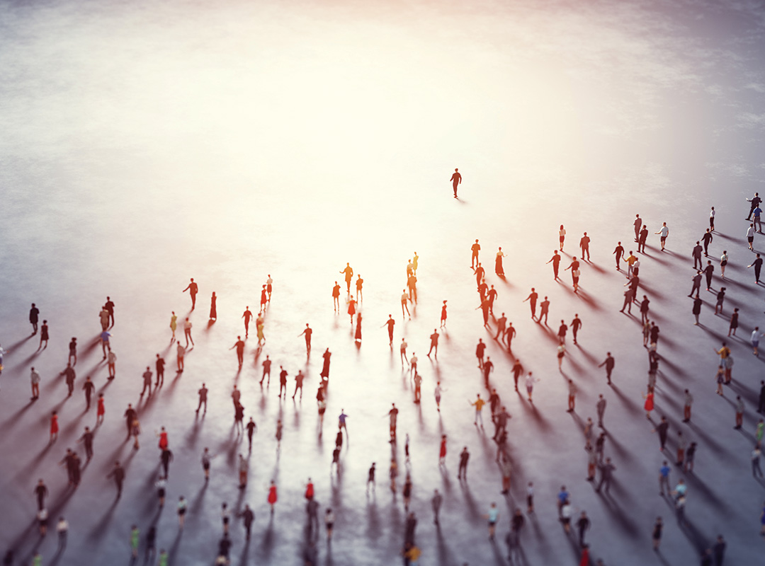 aerial image of a crowd of people in business suits following one leader